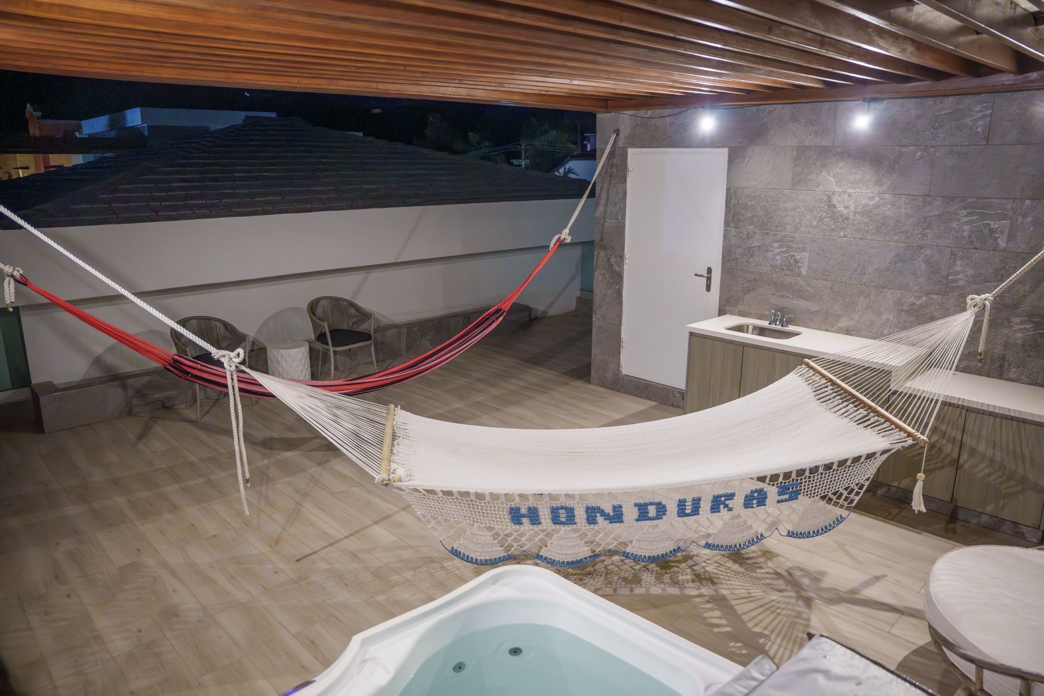 Rooftop hammocks and hot tub at night